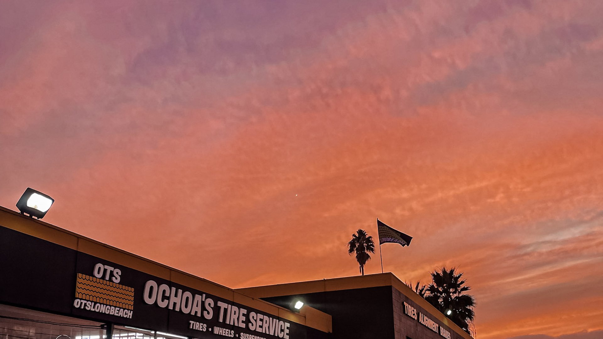 Ochoa's Tire Service storefront on Cherry Ave at sunset