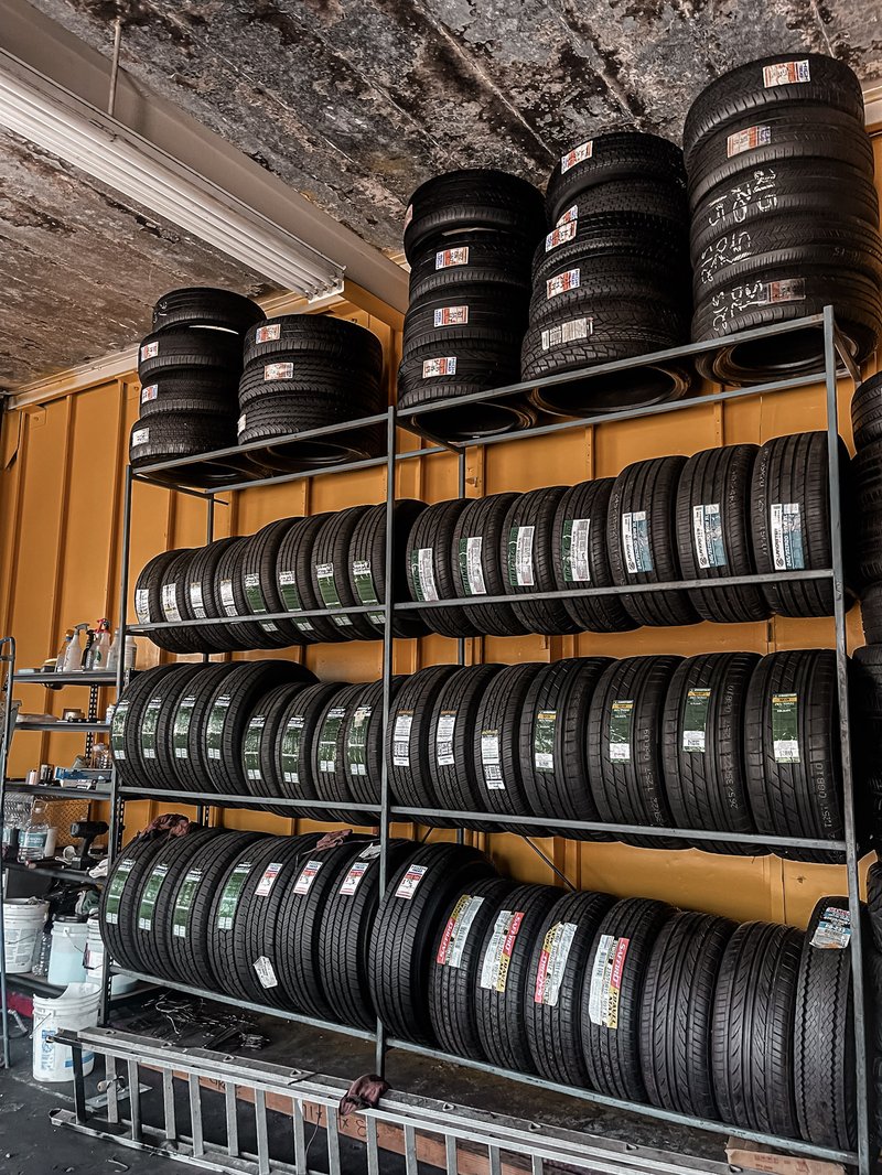 Inside our Paramount Blvd shop — tires organized and ready to install on the stock rack